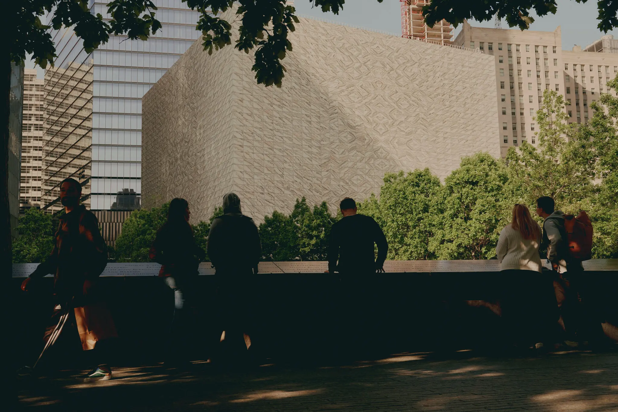 Pedestrians looking out over the tree line at the Perelman Performing Arts Center